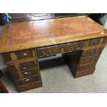 A Yew wood pedestal desk fitted with drawers and w