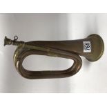 A copper and brass bugle with mouthpiece