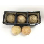 Five ivory billiard balls.