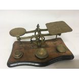 A set of early 20th century brass postal scales wi