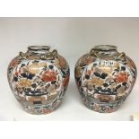 A pair of large Imari pattern vases with raised gi