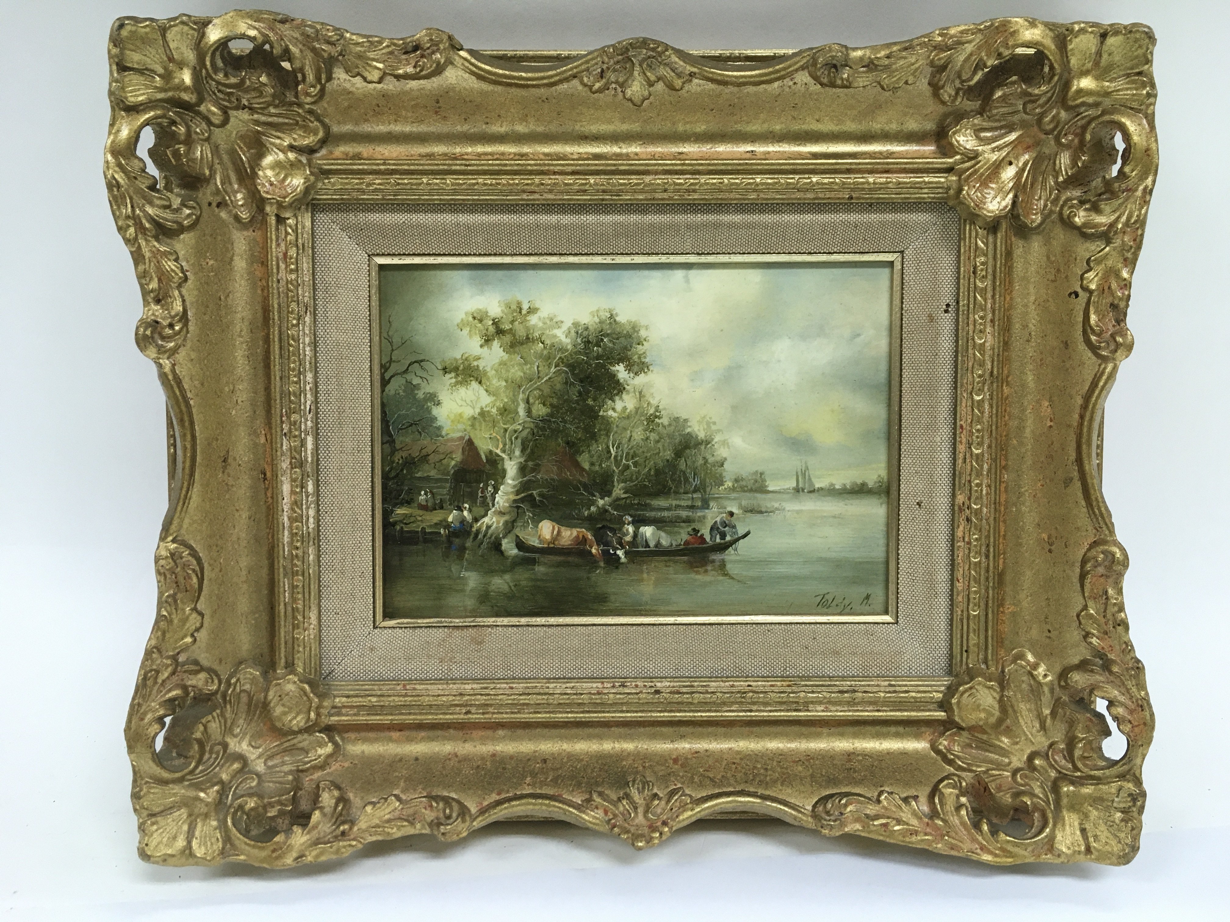 A gilt framed oil on board of a Dutch river scene