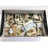 A box of loose cigarette cards, various subjects.