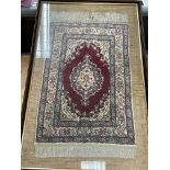 A framed silk rug measuring approximately 58.5cm x