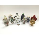 A collection of snuff bottles with various typical