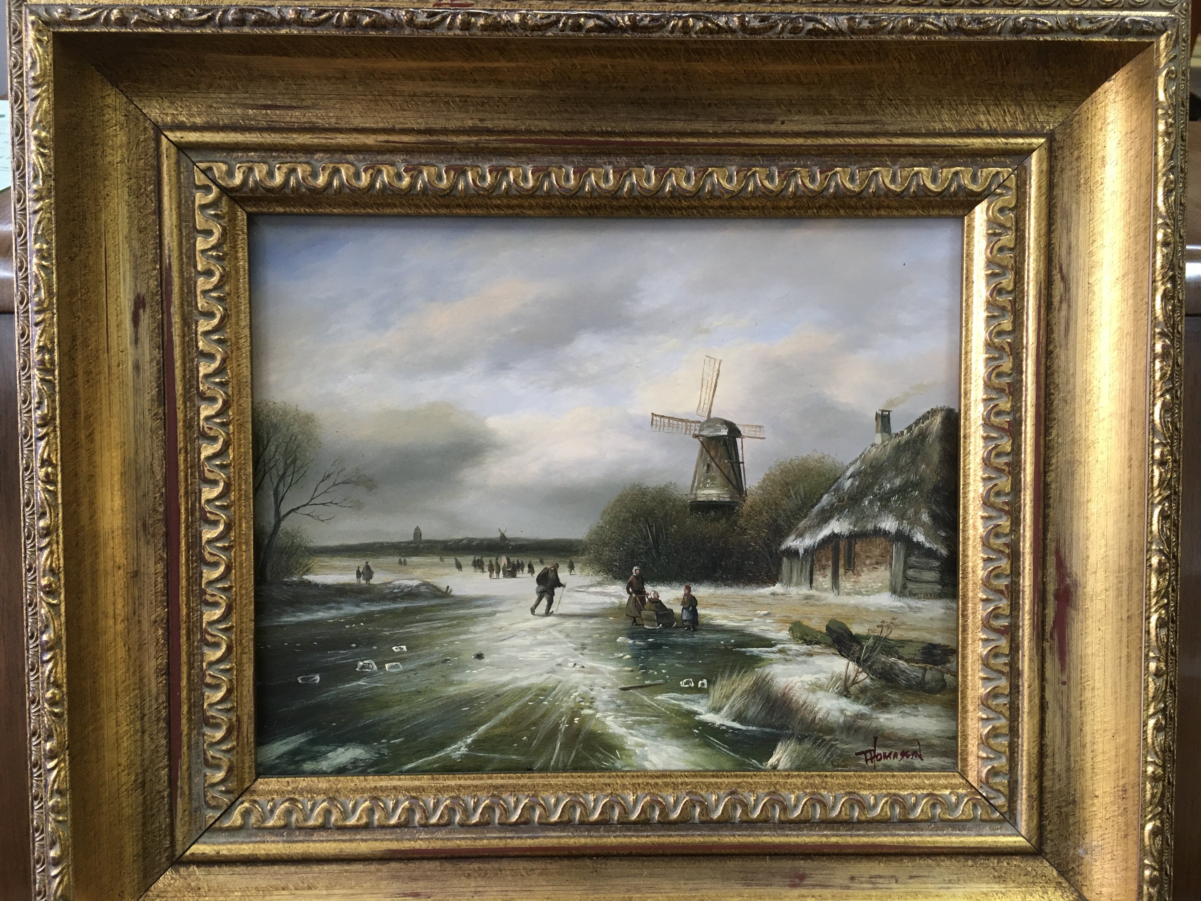 A gilt framed oil on board of a Dutch winter scene