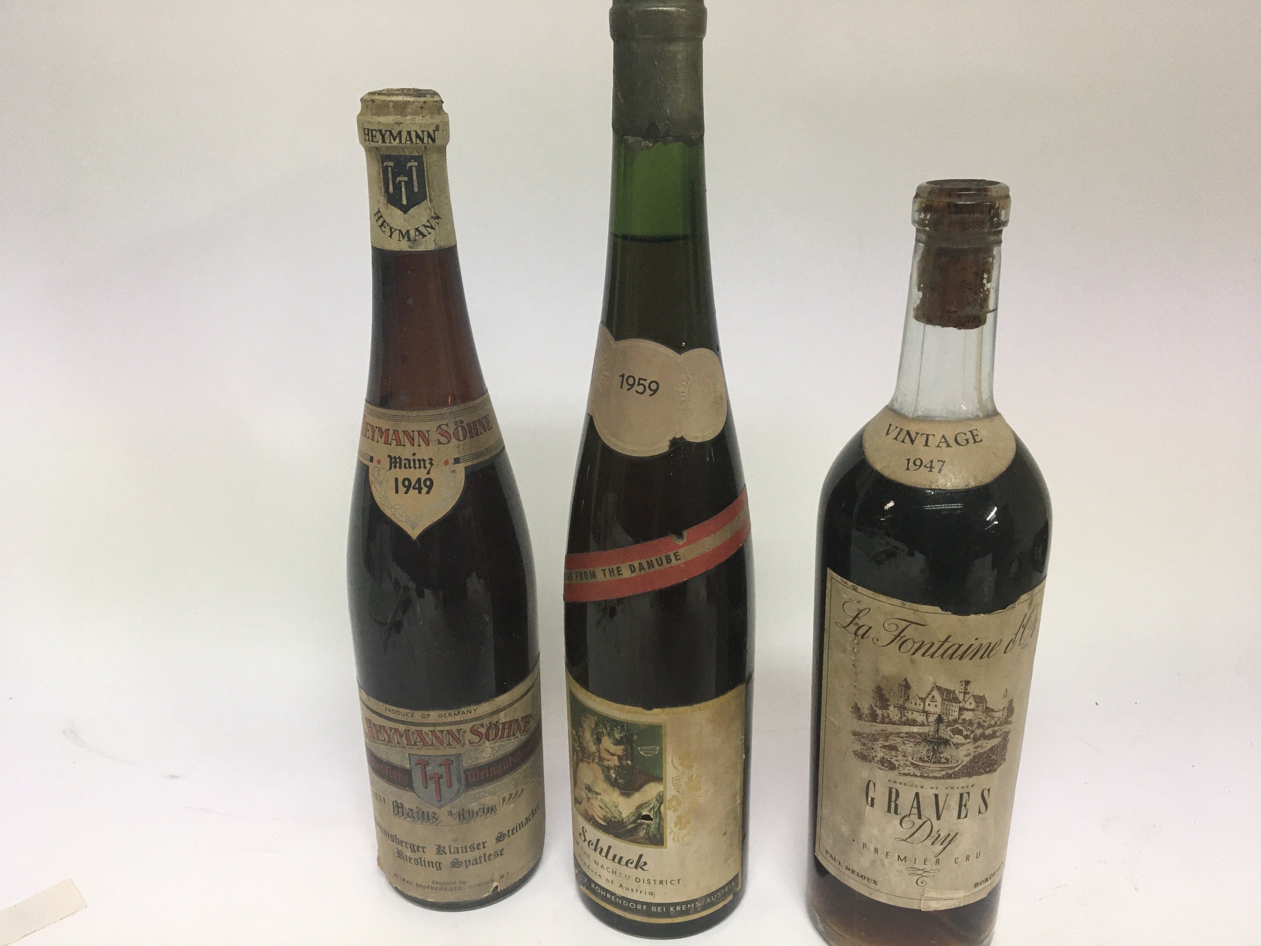 Three bottles of Vintage wineA bottle of 1949 S He