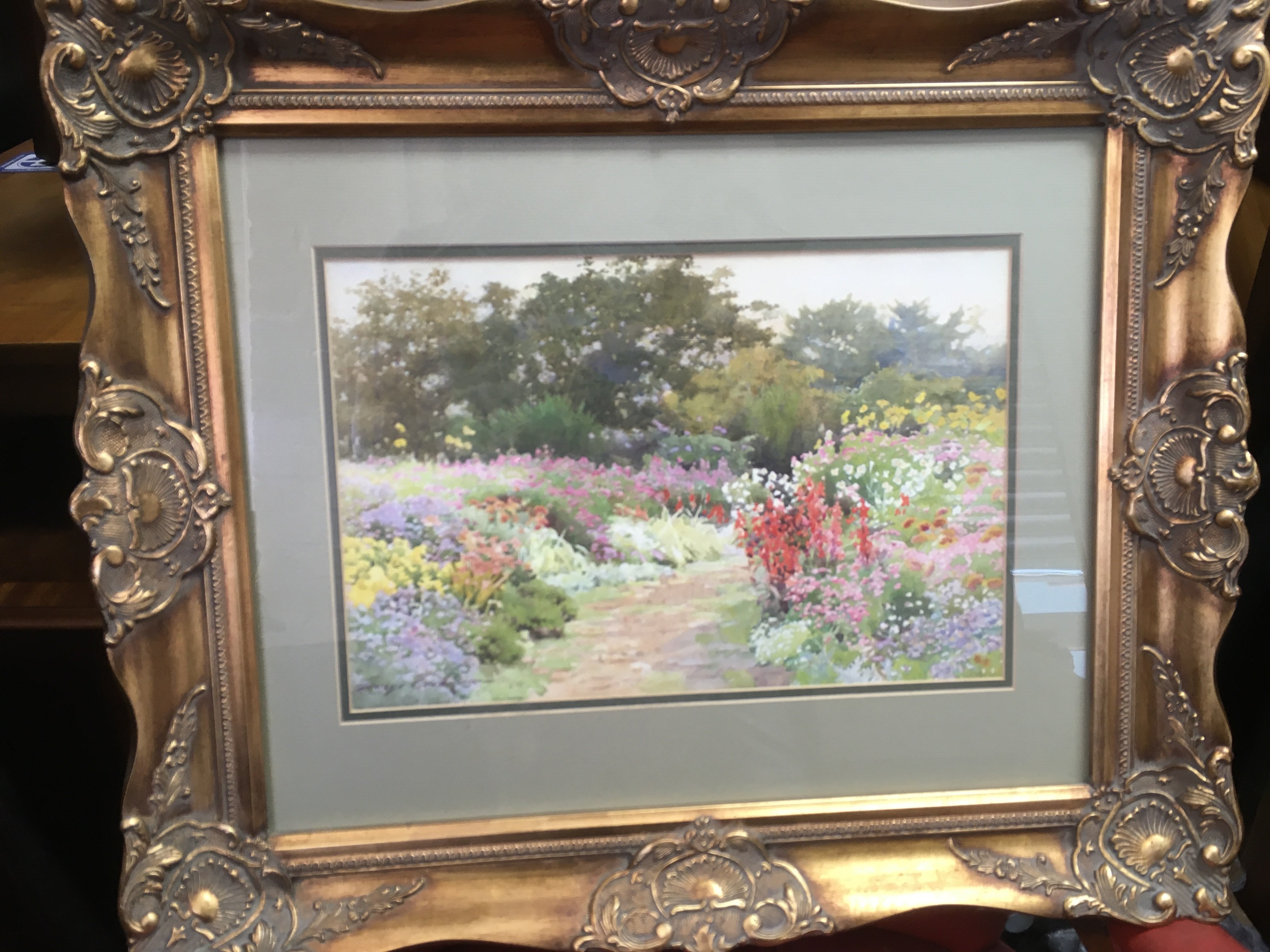 A gilt framed watercolour of a French garden scene
