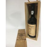 A Vintage bottle of Grahamâ€™s Port 1985 in a wood
