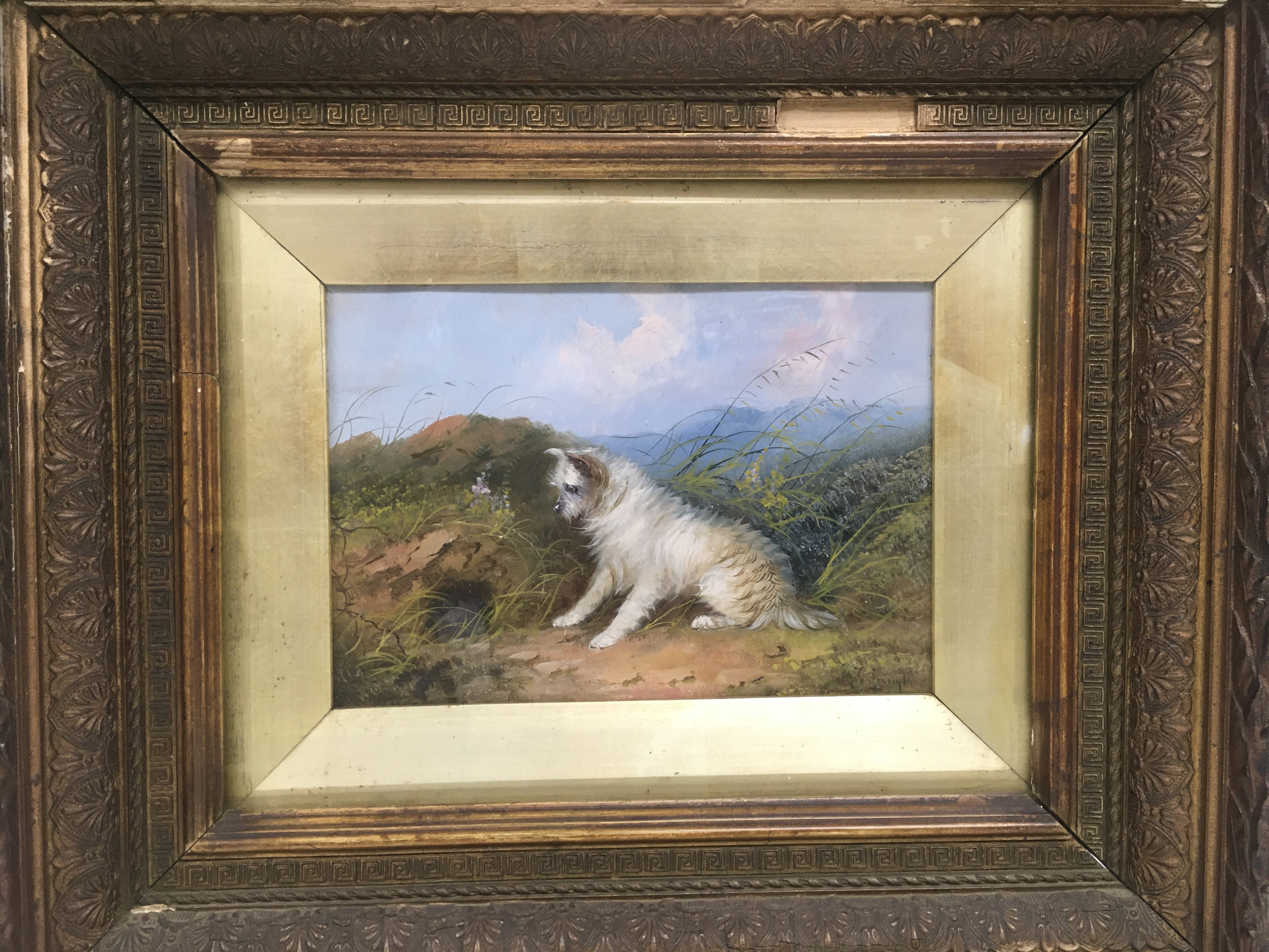 A gilt framed oil on board of a terrier in the sty