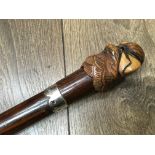 A novelty walking stick with carved parrot handle