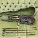 An cased Violin (in need of restoration) with 4 bo