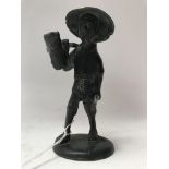 A small old bronze oriental figure carrying a pole