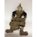 A Vintage string puppet from Thailand with a gold