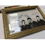 A framed picture of the Beatles with with printed