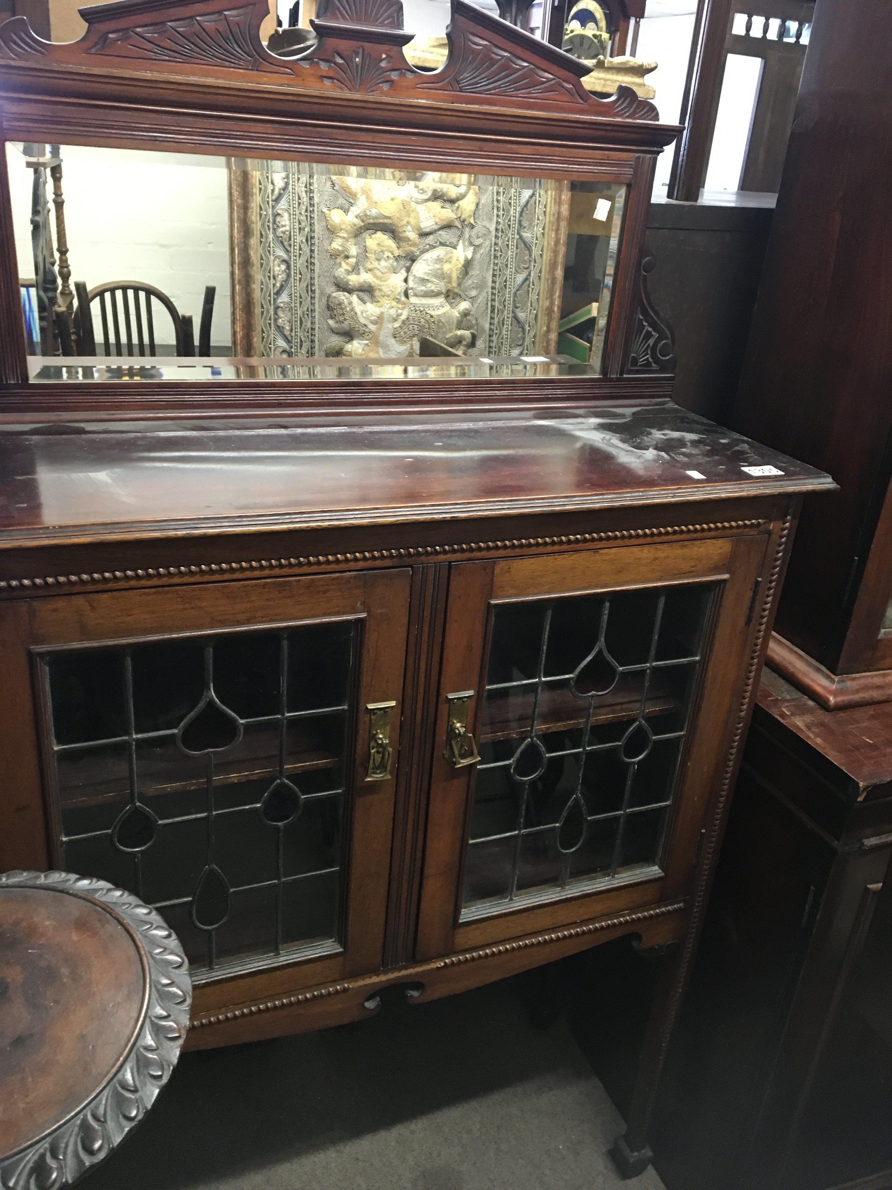 An Edwardian display cabinet with a mirrored back