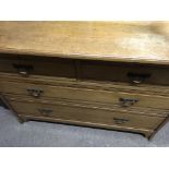 A oak chest of drawers fitted with two short and t