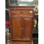 A 20th century Chinese mahogany cabinet with a sin