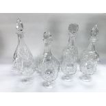 Four crystal and glass decanters and four glasses.