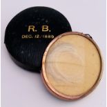 A lock of Robert Browning's hair in a yellow metal