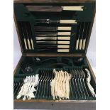 An oak cased canteen of cutlery.