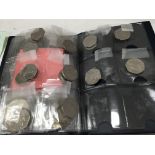 A folder containing 50 pence pieces and reproducti