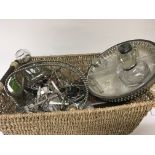 A basket containing a collection of silver plated