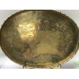 A brass oval tray engraved with oriental figures.3