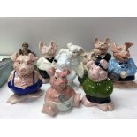 A collection of nine NatWest pigs including cousin