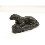 A bronze figure of a recumbent panther after Antoi