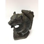 Carved figure of a bear walking with a large fish