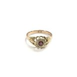 An 18ct gold ruby and diamond cluster ring, approx