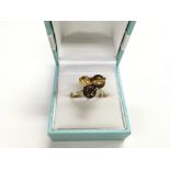 A 9ct gold spinning ring set with citrine, smoky q