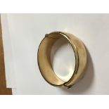 A gold tone bangle 37 grams.