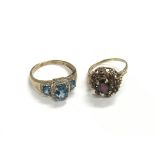 Two 9ct gold rings, one set with topaz the other w