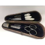 A leather sewing case containing a sewing set .