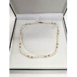 A string of cultured pearls with a 9ct gold clasp