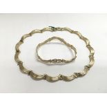 A 9ct gold necklace and matching bracelet, approx