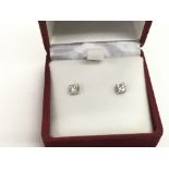 A pair of 18ct white gold solitaire diamond ear st