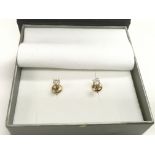 A pair of 14k gold diamond ear studs, approx 0.5g.