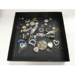 A box of over 40 silver pendants and charms.