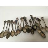 A collection of silver spoons some with enamel dec