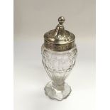 A George III silver topped glass sugar shaker, som