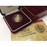 A gold proof 2002 half sovereign with fitted box .