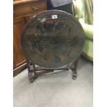 A carved hardwood oriental folding table the round