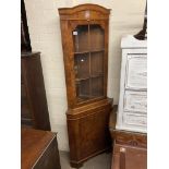 A burr walnut veneered corner cabinet