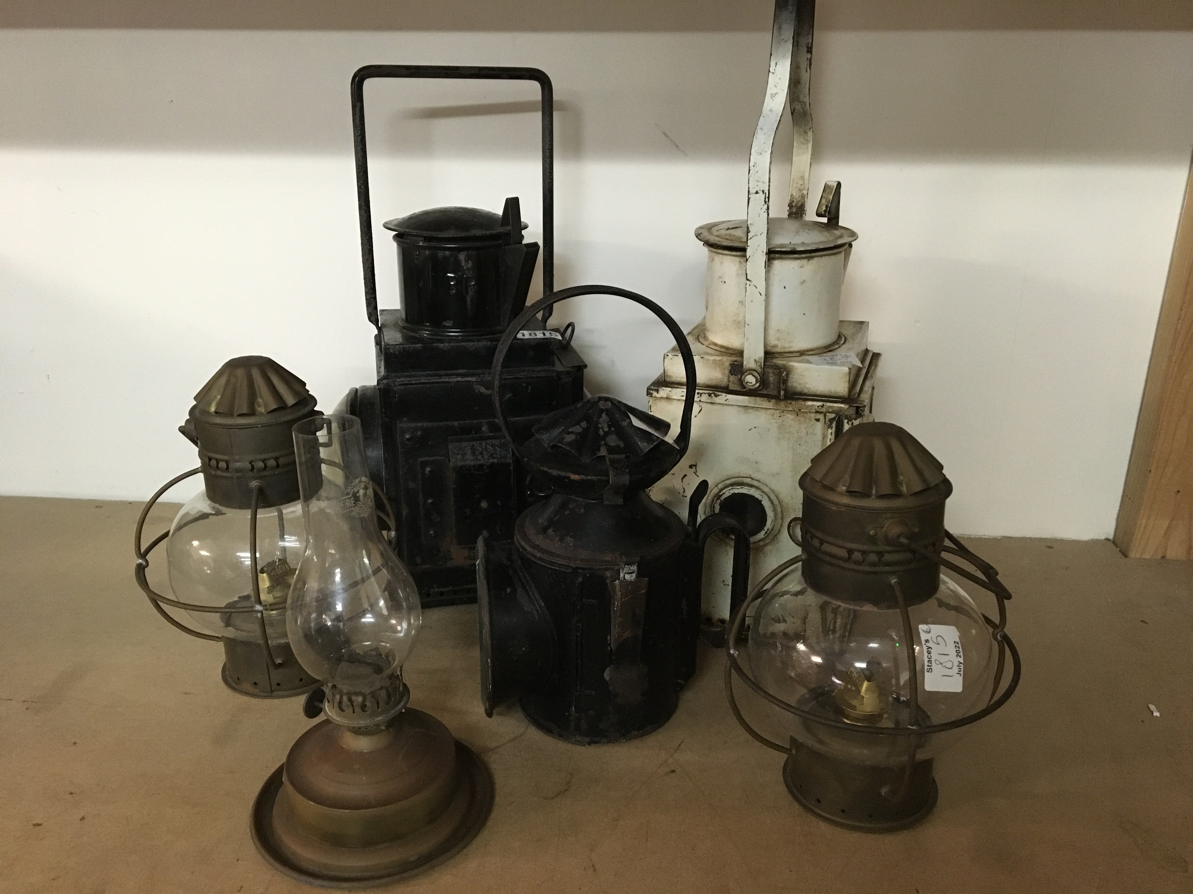 Five oil lamps including two railway lamps