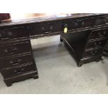 A Reproduction mahogany desk fitted with nine draw