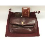 A Must De Cartier burgundy leather clutch bag.