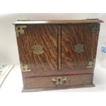 A oak stationary boxwith three drawers and open do